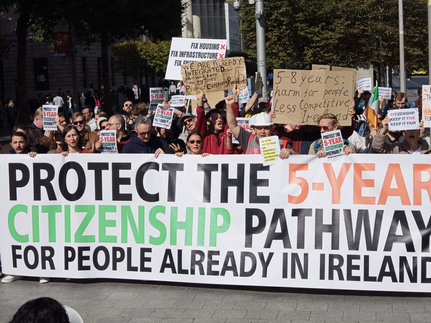 The crowd behind the ‘Protect the 5-year citizenship pathway’ banner on O’Connell Street
