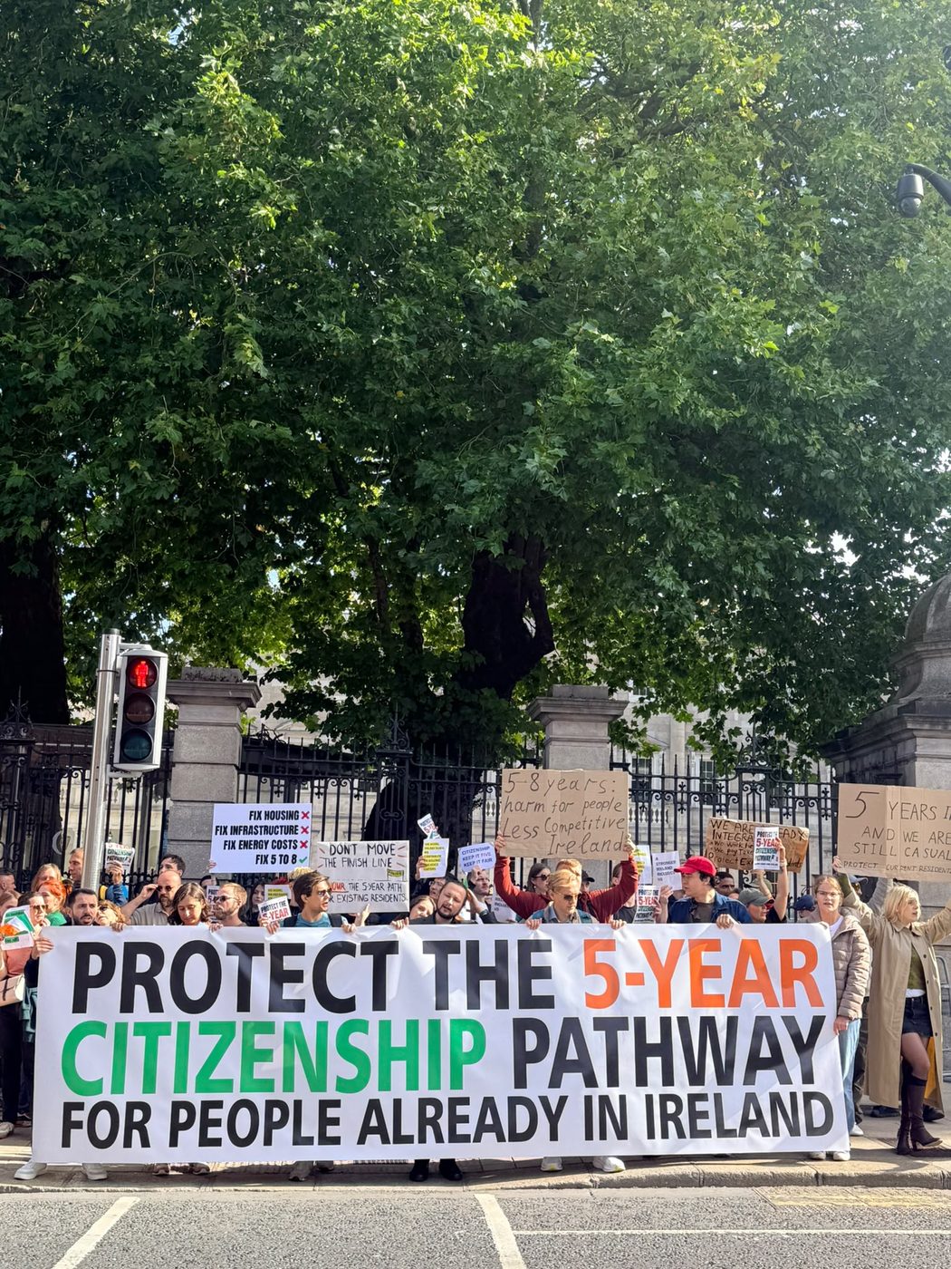 The banner held along the railings at Leinster House, with signs reading ‘Fix housing, fix infrastructure, fix energy costs’ and ‘5 years in, and we are still casual’