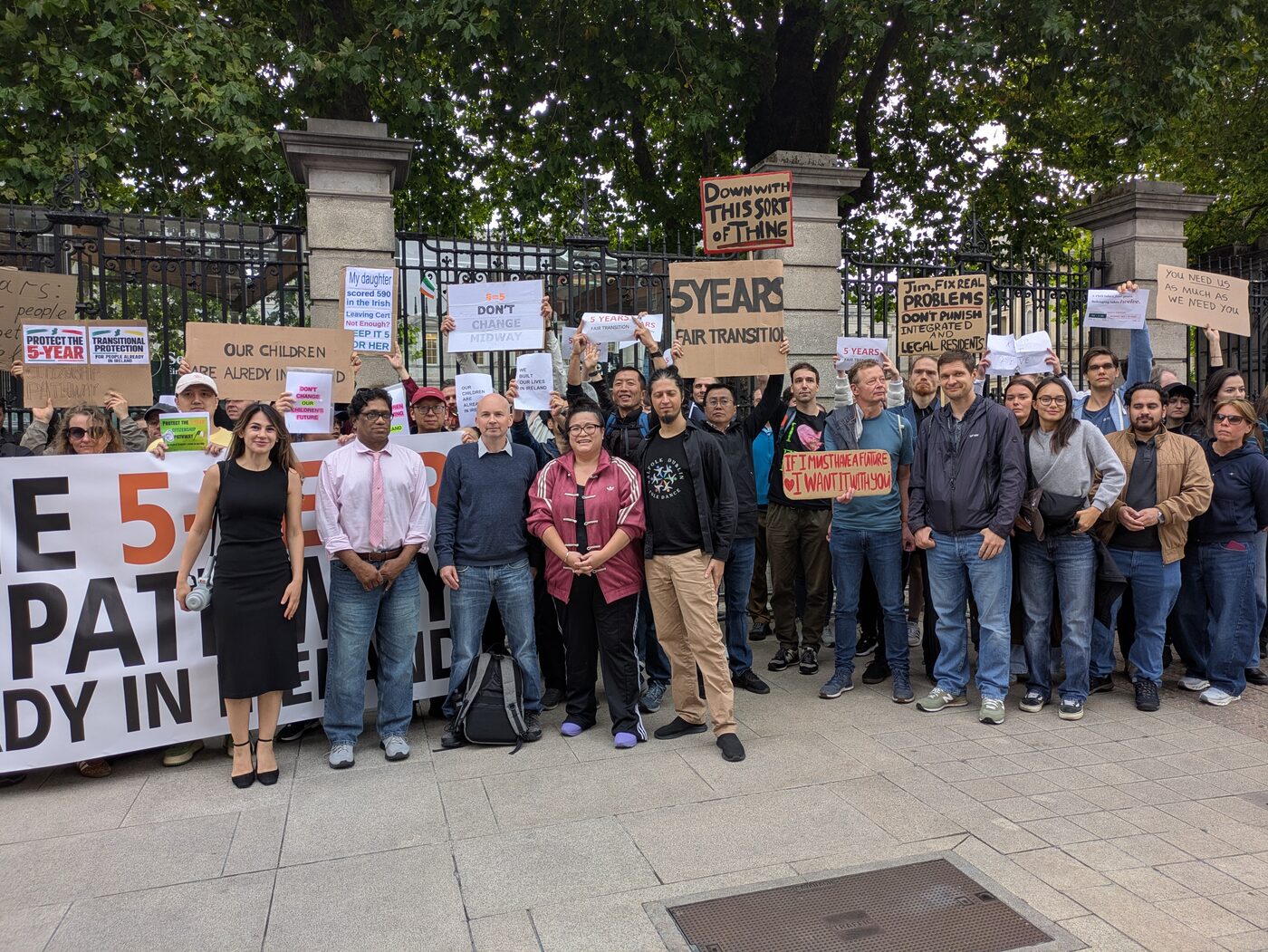 The gathering at the gates of Leinster House, with a sign reading ‘Down with this sort of thing’ held up above the crowd