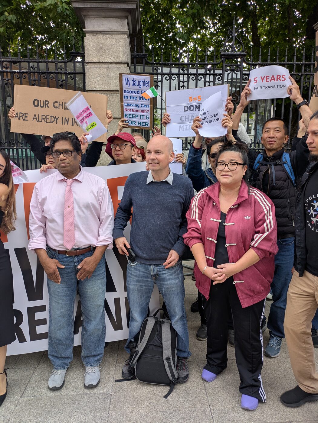 Protesters at the gates of Leinster House with signs reading ‘Our children are already in Ireland’, ‘My daughter … in the Irish Leaving Cert. Not enough? Keep it 5 for her’, ‘Don’t change midway’ and ‘5 years, fair transition’